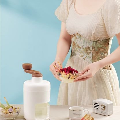 Charchi stainless steel ice crusher with white body and brown handle on kitchen table
